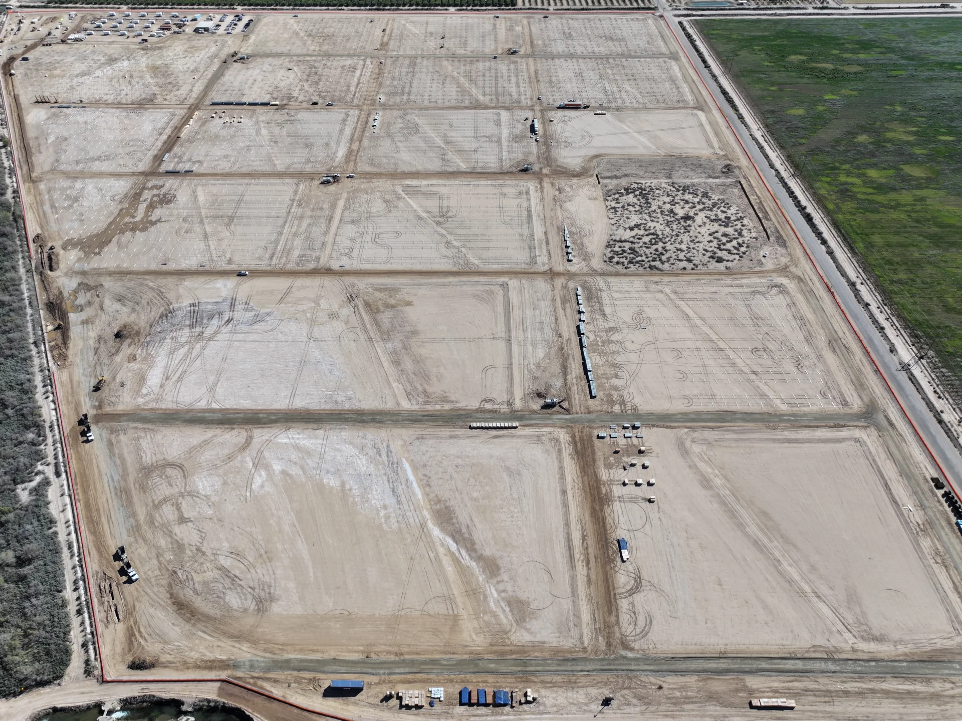 Aerial view of site preparation, access roads and foundation rows